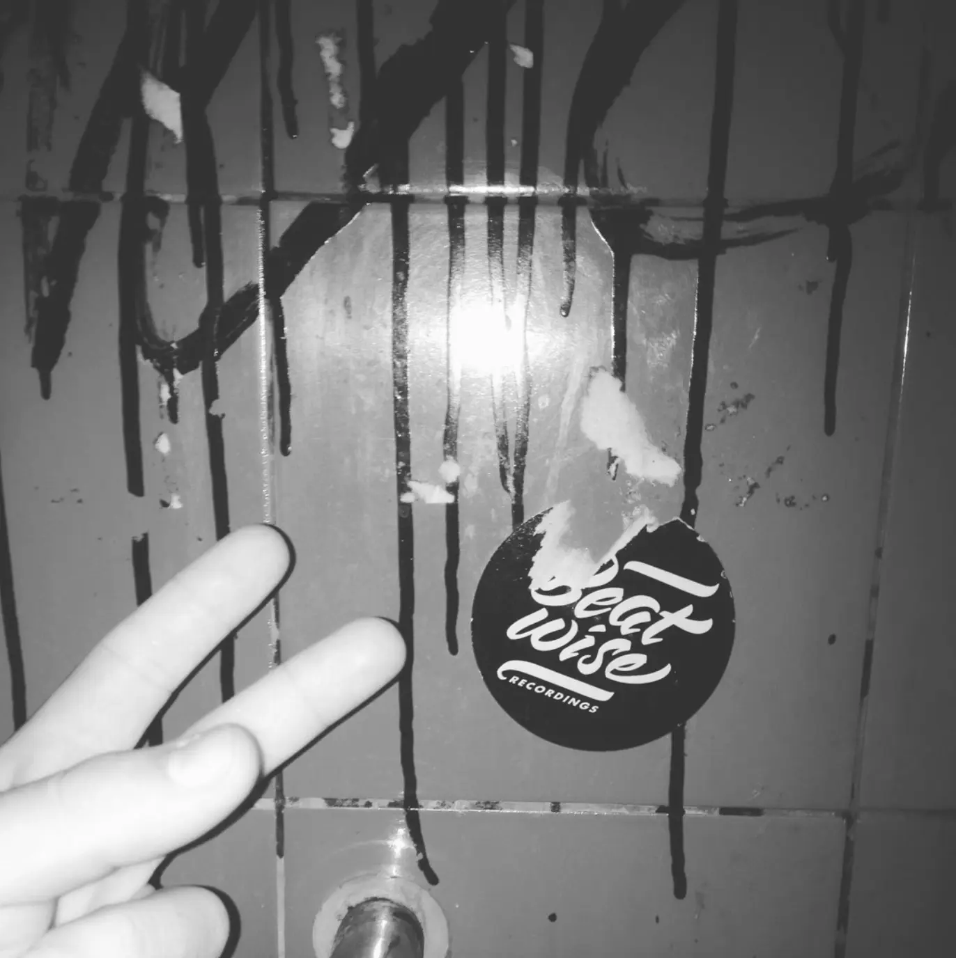 CESRV's hand and a Beatwise Recordings sticker in the Fosfobox bathroom